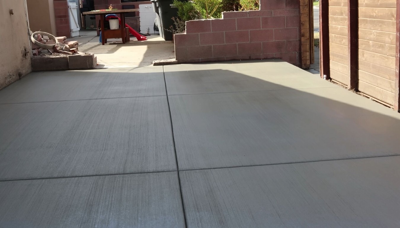 Low-maintenance concrete patio installation in Jackson, MS backyard